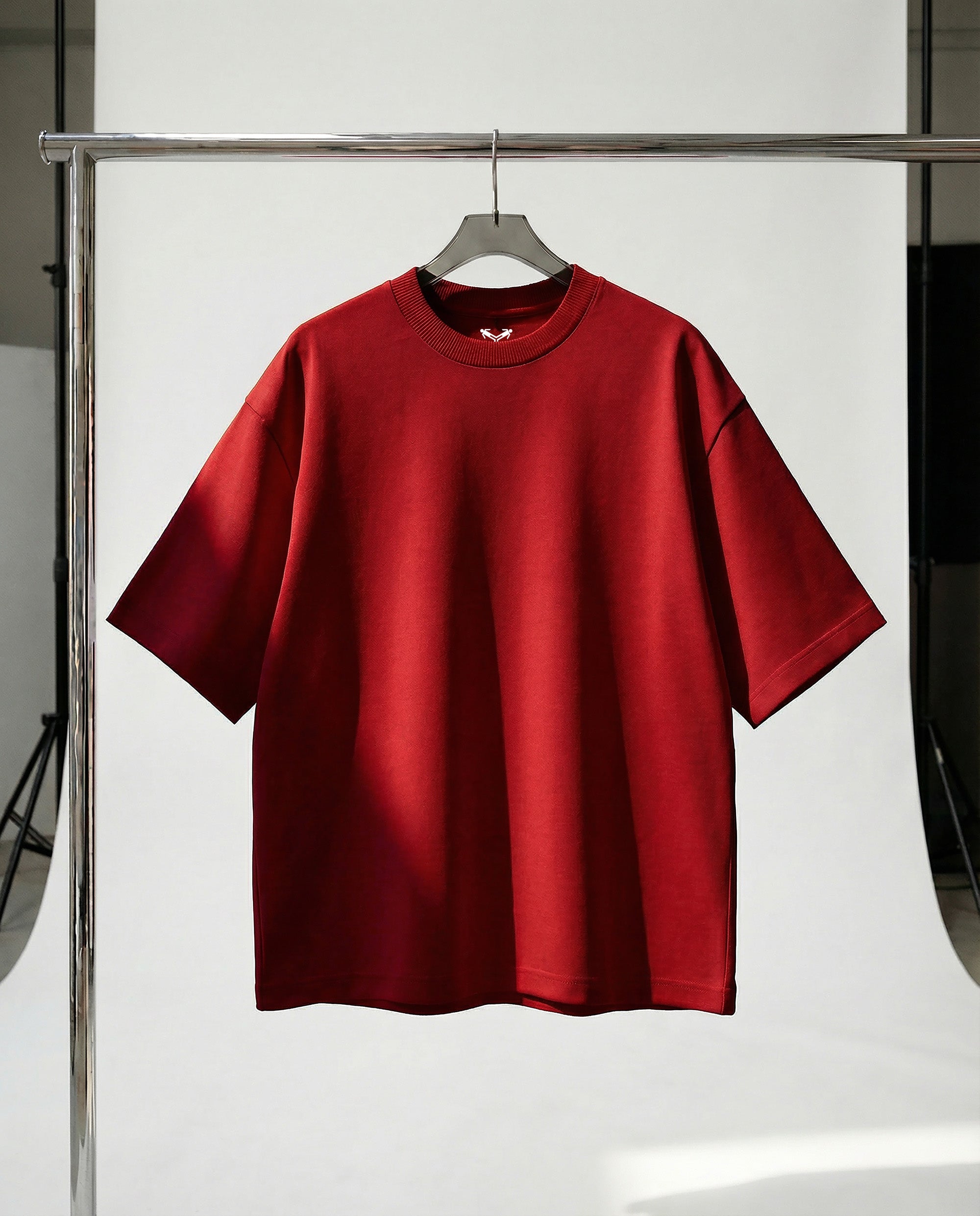 Red t-shirt on a hanger against a white background
