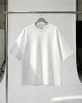 White t-shirt on a hanger against a white background