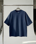 Navy blue t-shirt on a hanger against a white background